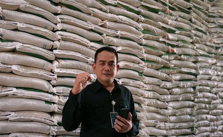 Pemimpin Wilayah Bulog Sumut di depan tumpukan beras di gudang Bulog Jalan Mustafa Medan